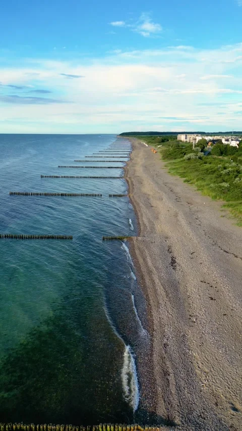 Vertical Drone Flight Along Baltic Sea Beach and Wooden Groynes Stock Footage 341887514
