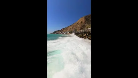 Vertical Drone Flight Along Surf and Rocky Malibu Coast Stock Footage 346545967