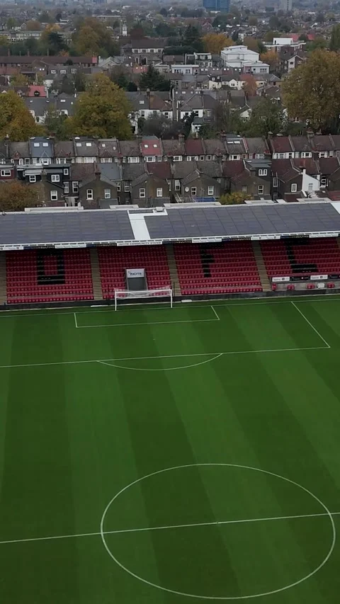 Vertical Drone flight diagonally over Leyton Orient Football pitch, with logo Stock Footage 312430074
