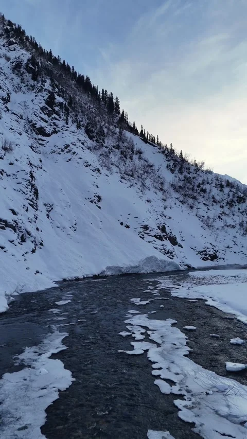 Vertical drone flight over incy river Stock Footage 327690933