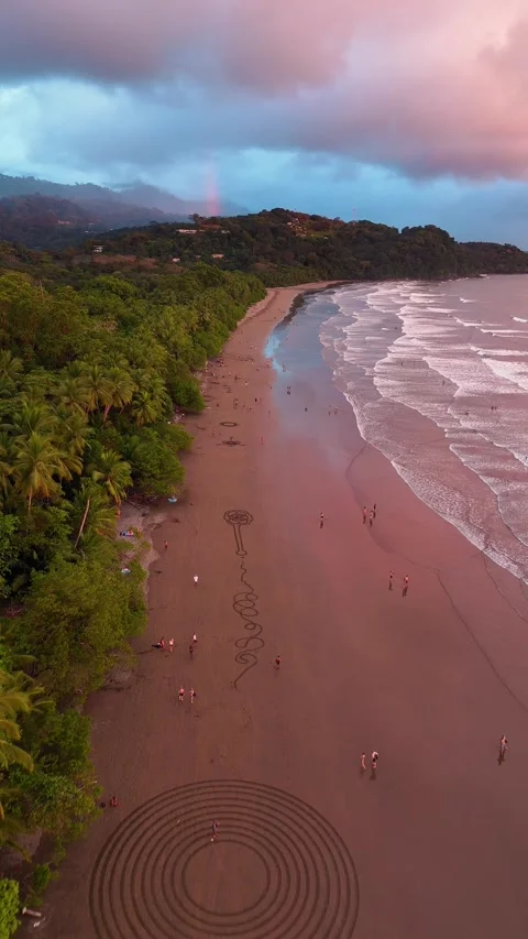 Vertical Drone Flight Over Sand Art at Playa Uvita Sunset Stock Footage 328598400