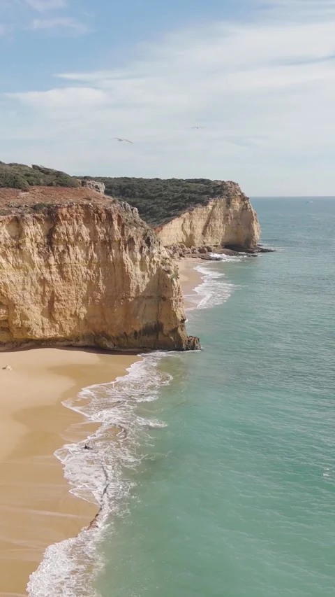 Vertical Drone Flight Revealing Praia do Torrado Beach in Ferragudo 動画素材 347123739