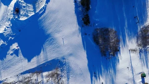 Vertical Drone Flight Ski Slope Against Skier Direction Winter 4K Video stock 328619750