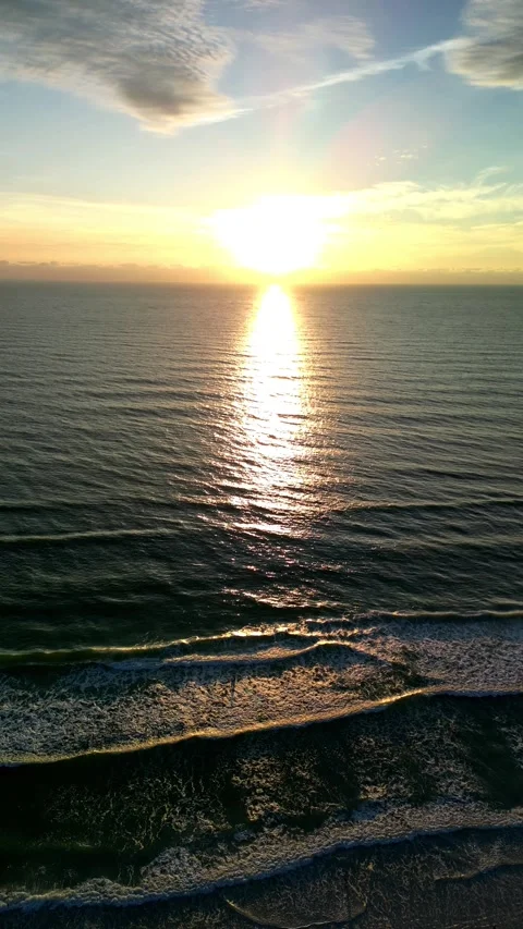 Vertical Drone Flight Toward Ocean Sunset and Waves at Golden Hour Stock Footage 330700532