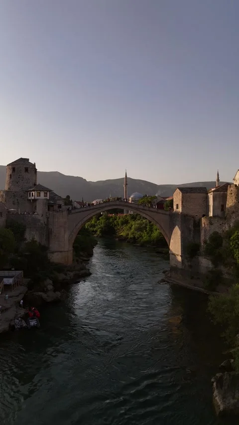 Vertical Drone Fly Under Stari Most Bridge Tracking Toward Mostar Mosque 4K Stock Footage 337831173
