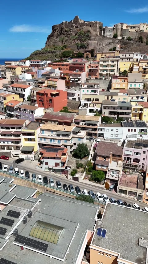 Vertical Drone Flying Backward Over Colorful Houses Of Castelsardo In Sardinia Stock Footage 340223104