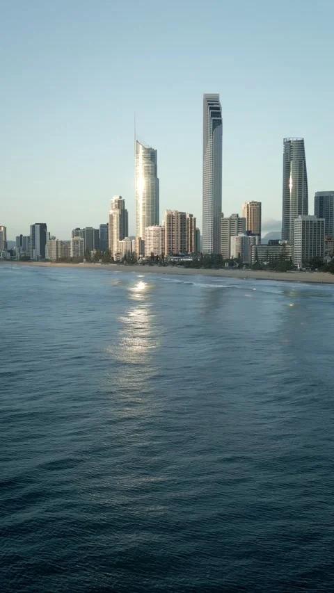 Vertical drone flying backwards out to sea Surfers Paradise skyline Gold Coast Vídeo Stock 329005313