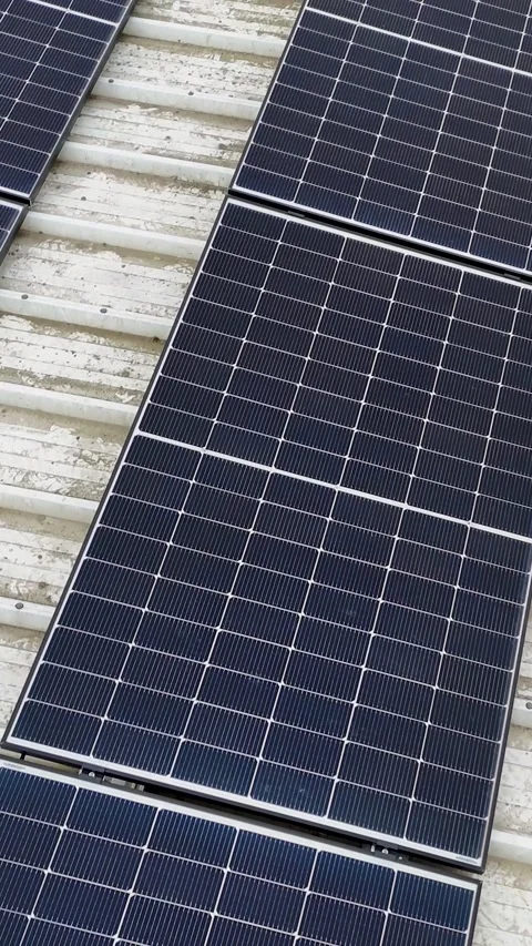 Vertical Drone Flying Forward Over Solar Panels On Corrugated Metal Roof Stock Footage 330750965