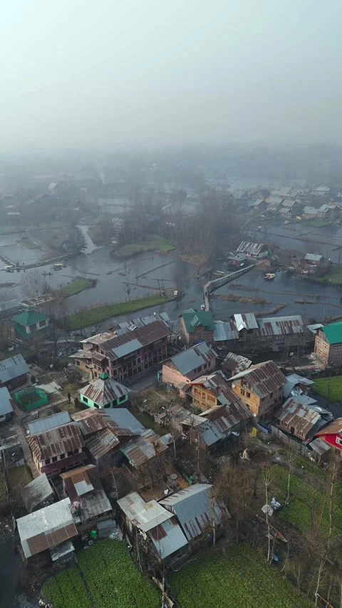 Vertical drone flying over the frozen lanes and locked waterways of Dal Lake in Stock Footage 311020165