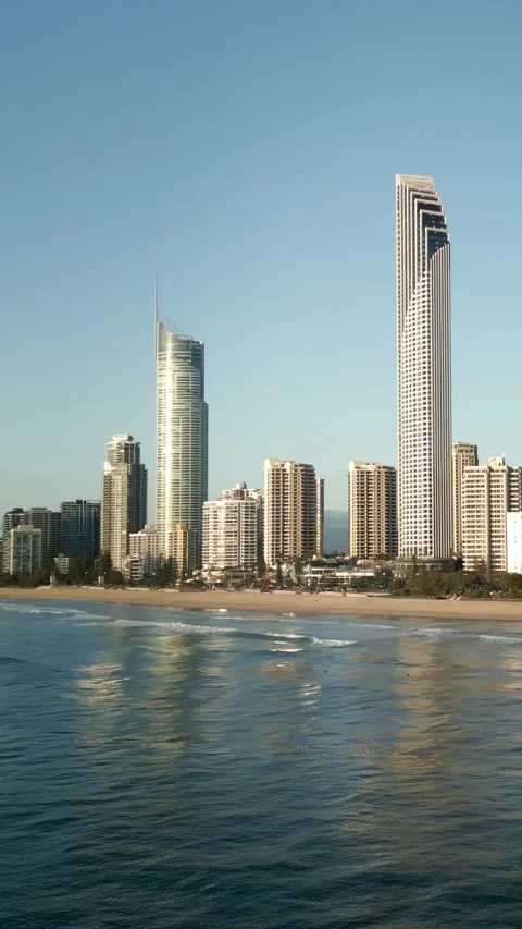 Vertical drone flying towards beach two surfers boards water Surfers Paradise Vídeo Stock 329005303