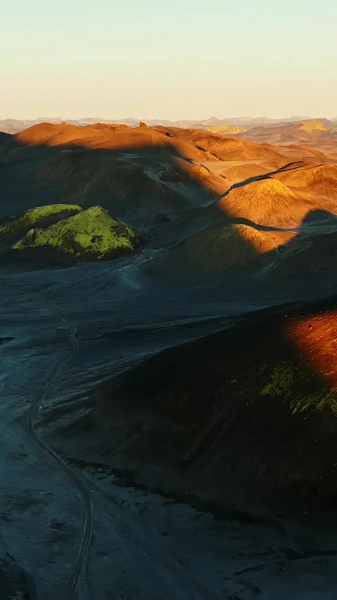Vertical drone flyover of Icelandic volcanic highlands—black sand hills and Stock Footage 330903249
