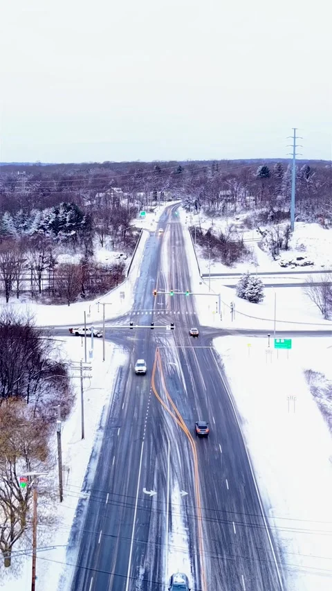 Vertical Drone Flyover Of A Intersection With Cars Driving After A Snow Storm Stock Footage 334586890