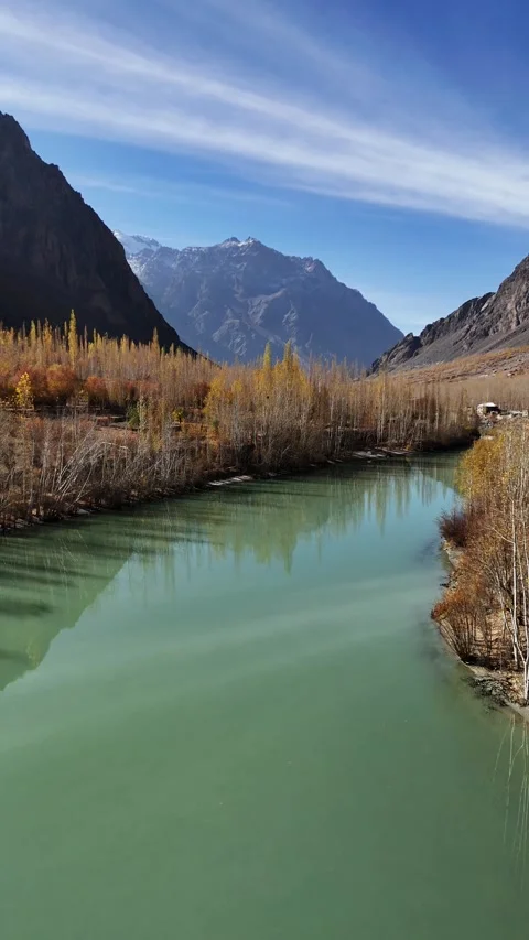 Vertical drone flyover of Suru River as it weaves through fall-colored Stock Footage 310662399