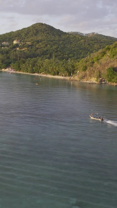 Vertical drone following shot of a moving speed boat with vibrant sunset Stock Footage 319819352