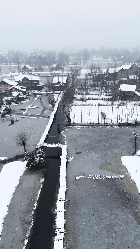Vertical drone footage capturing the quiet elegance of wooden bridges dusted Stock Footage 311021693