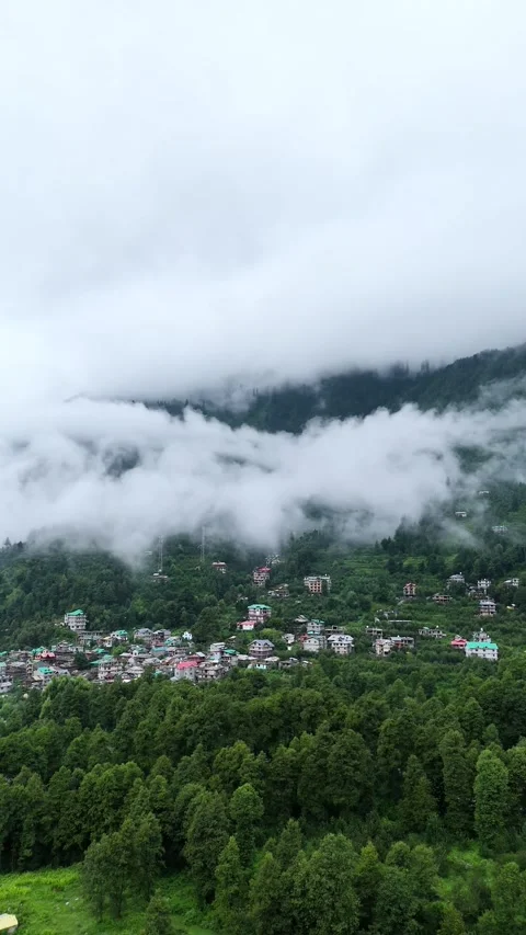 Vertical drone footage capturing village homes nestled in green Himalayan Stock Footage 310659262