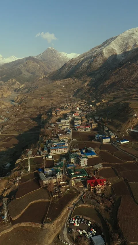 Vertical Drone footage of Manang’s stone houses under the watchful gaze of snowy Stock Footage 311019228