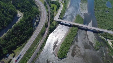 Vertical Drone Footage of Matapedia River &amp; Nearby Highway, Railway &amp;  Bridge Stock Footage 341827935