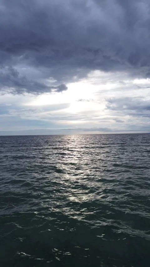 Vertical Drone Footage of Over Blue Sea with Sunlight and Blue Sky Stock-Footage 266090710