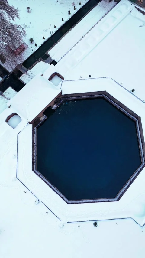 Vertical drone footage performing an elegant arc movement over Verinag spring’s Stock Footage 311128755