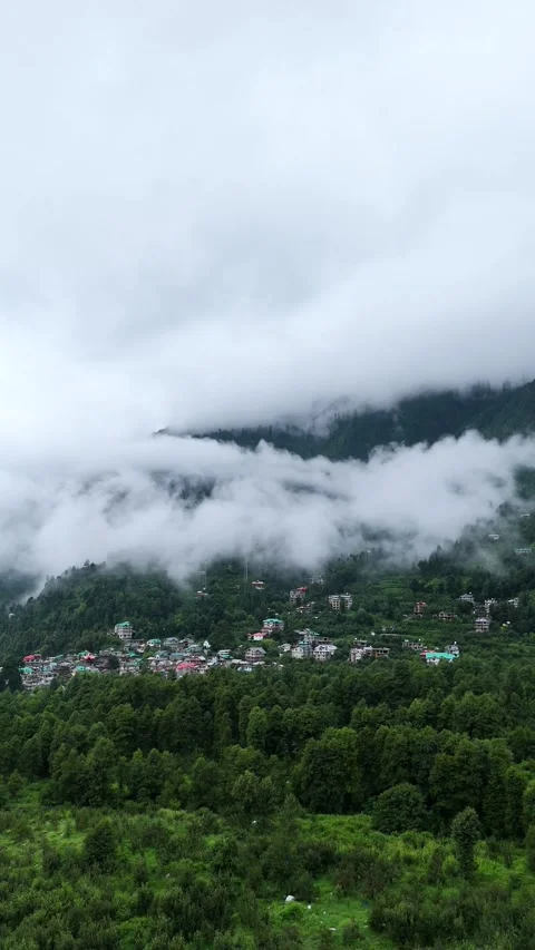 Vertical drone footage with scenic layers of hills, trees, and sky. Stock Footage 310659438