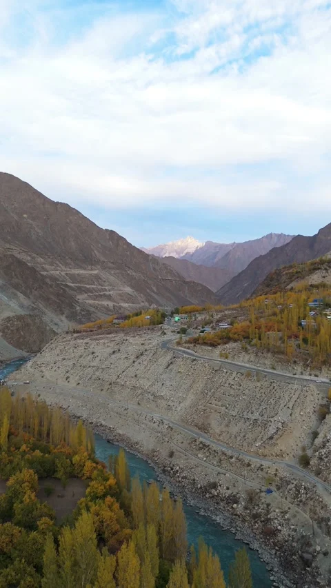 Vertical drone footage of a serene river in the Himalayas during fall. Stock Footage 310661660