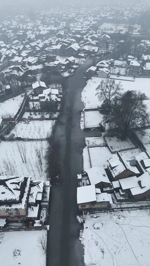 Vertical drone footage of snow falling on the houseboats and shikaras in Dal Stock Footage 311021812