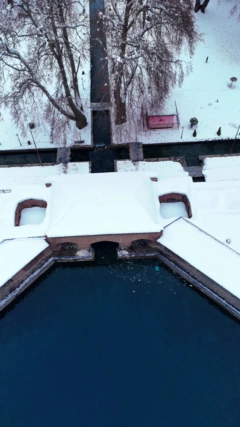 Vertical drone footage with a top-down aerial view revealing Verinag spring’s Stock Footage 311129015