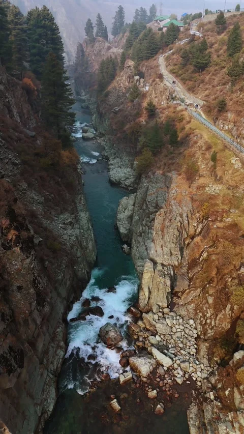 Vertical drone footage where the mighty water carves its path through the 動画素材 311152092