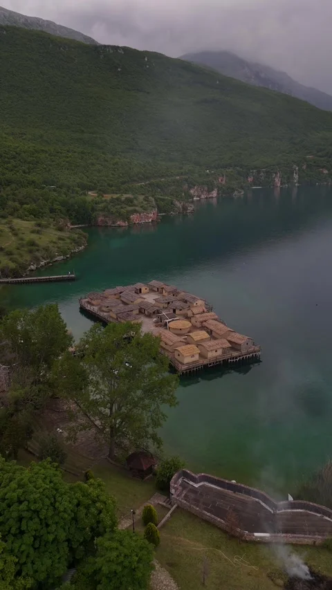 Vertical Drone Forward Tilt Down of Bay of Bones Stilt Houses with Smoke, 4K Vídeos de archivo 337178154