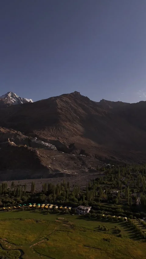 Vertical drone gliding toward the monastery walls built into solid rock. Stock Footage 310900890