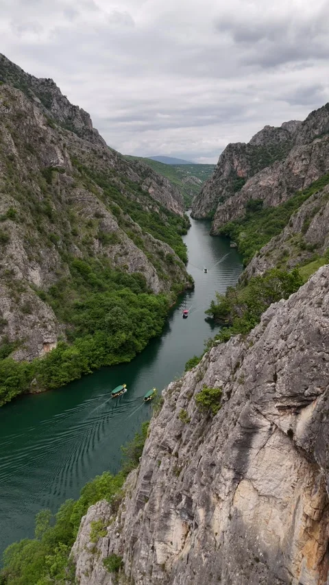 Vertical Drone Hover and Reveal of Tour Boats in Matka Canyon, 4K Stock Footage 337175862