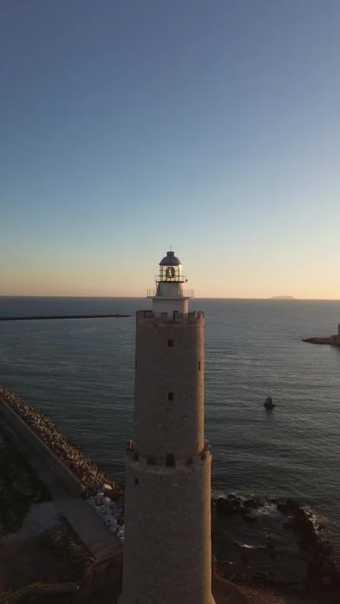 Vertical drone orbit around lighthouse at sunset, Livorno Stock Footage 345131758