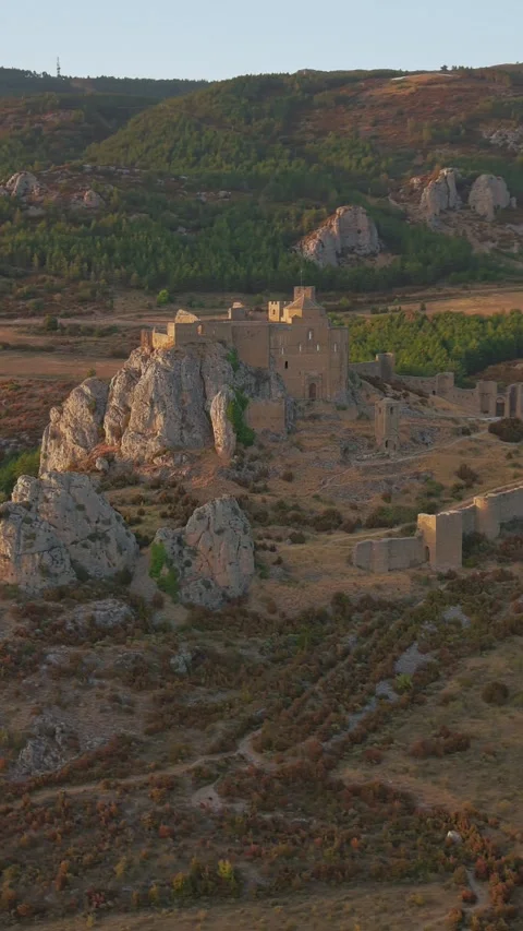 Vertical drone orbit around Loarre Castle and Pyrenean foothills Stock Footage 345095872