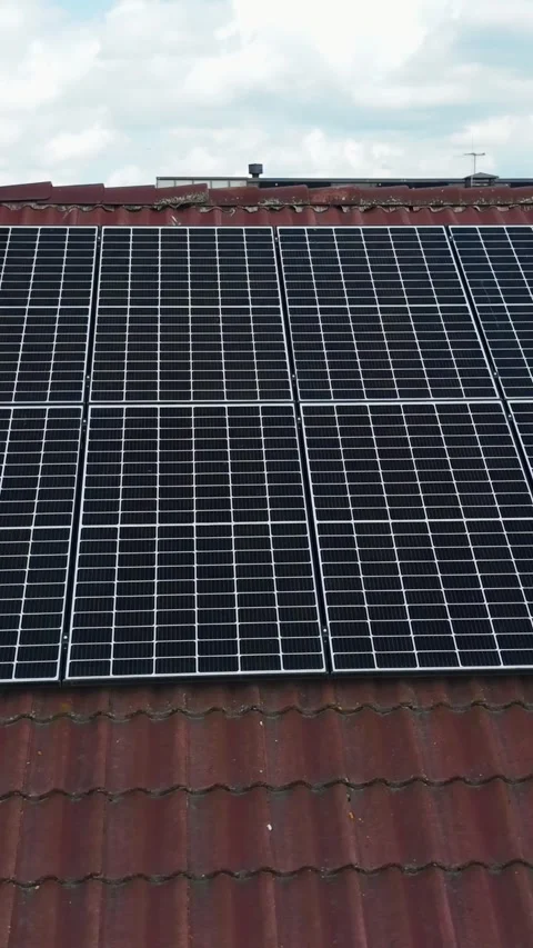 Vertical drone orbit extreme close-up of rooftop solar panels on terracotta 動画素材 315078583