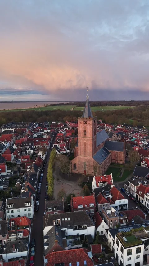 Vertical Drone Orbit of Naarden Grote Kerk and Historic Star Fort at Sunset Stock Footage 332176519
