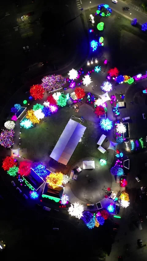 Vertical Drone Orbit Over Holiday Light Park at Night Видео 348420592