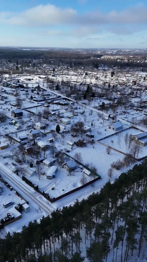Vertical Drone Orbit Over Snow Covered Countryside Near City Skyline Stock Footage 337900967