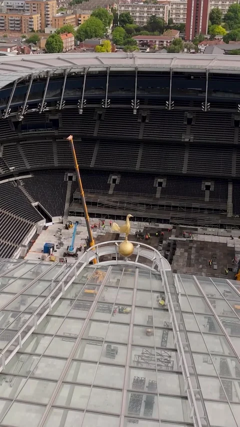 Vertical Drone Orbits Tottenham cockerel logo with concert stage setup below on Stock Footage 311118880