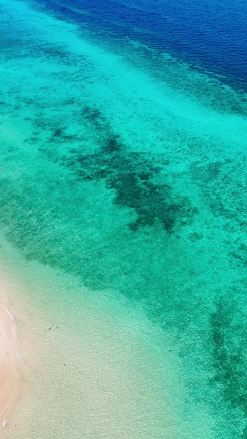 Vertical drone over multishade blue water and white sand, Koh Ngai – 4K Stock Footage 325022374