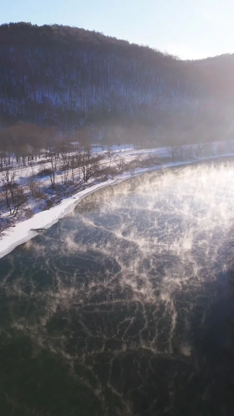 Vertical Drone Over River with Steam Snowy Winter Morning 4K Video stock 330688540