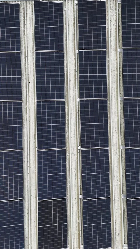 Vertical Drone Pan Right Over Dark Solar Panels On Modern Building Facade Stock Footage 330750009