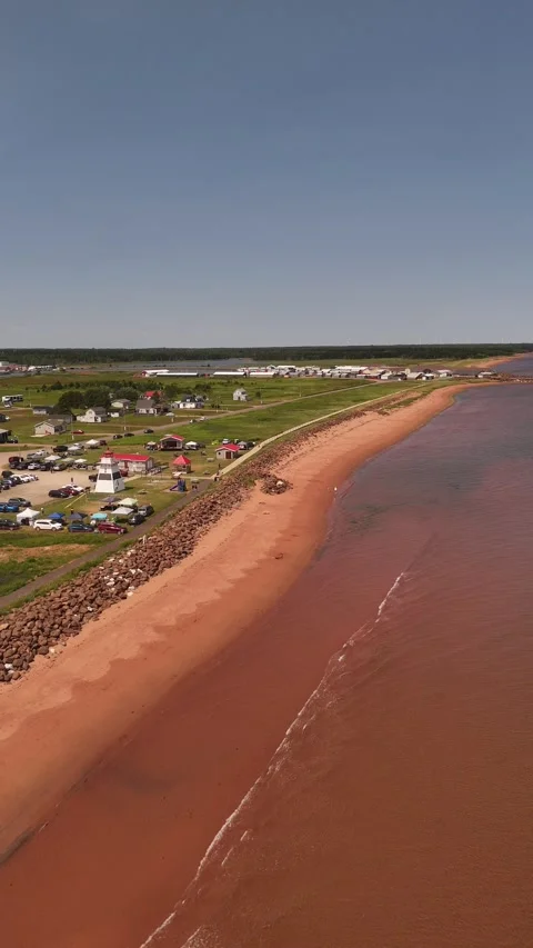 Vertical Drone Pull-Back Over Red Sand Beach &amp; Lighthouse, PEI Canada Stock Footage 341362686
