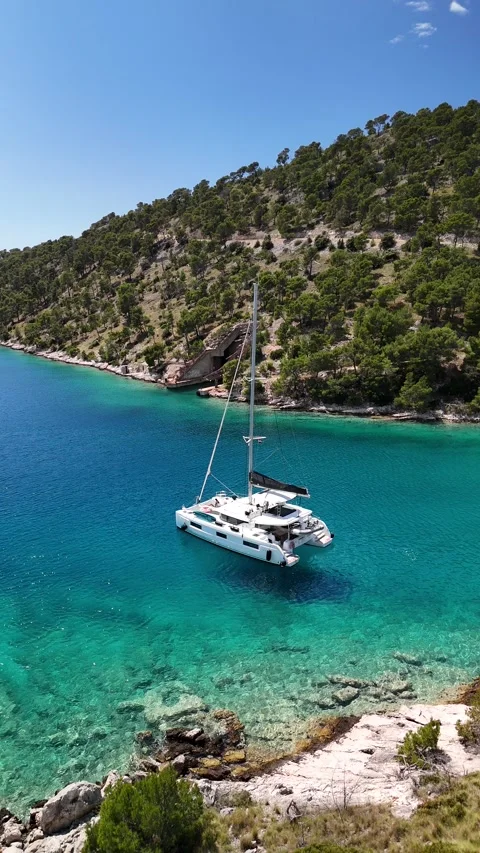 Vertical Drone Pull Back: Smrka Bay, Brač Island - Submarine Shelter &amp; Boats Video stock 313483980