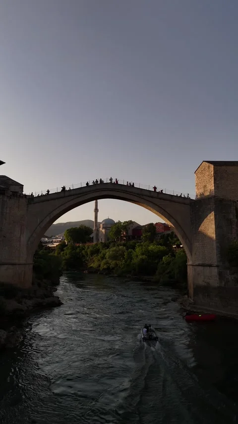 Vertical Drone Pull Back From Stari Most Bridge with Passing River Boats 4K Vídeos de archivo 337831270
