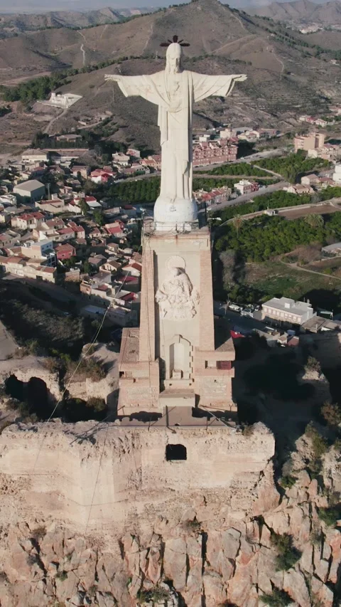 Vertical Drone Pullback Over Christ of Monteagudo and Castle Stock Footage 332110024