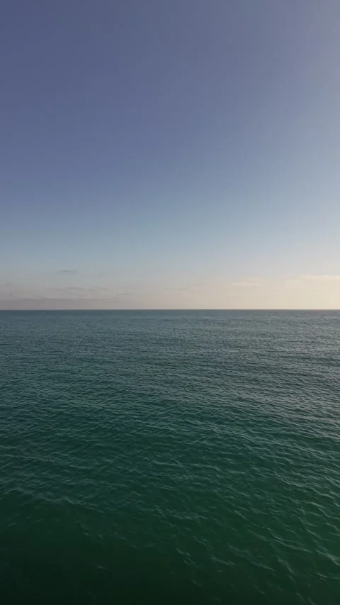 Vertical Drone Pullback Over Ocean in Malibu on Sunny Day 4K Stock Footage 331764538