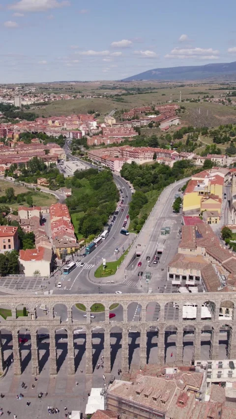 Vertical Drone Pullback Revealing Segovia Roman Aqueduct and Cityscape Stock Footage 332141310