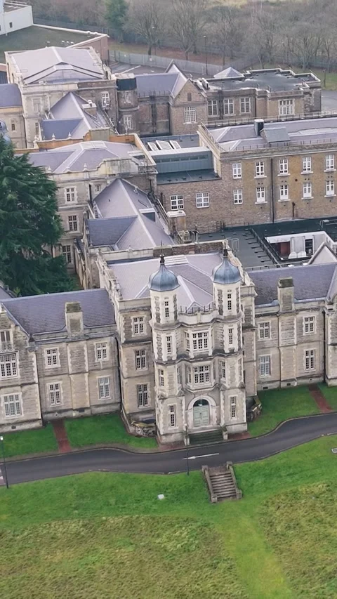 Vertical Drone reverse by Snaresbrook Crown Court, showing grassy grounds Stock Footage 328503409