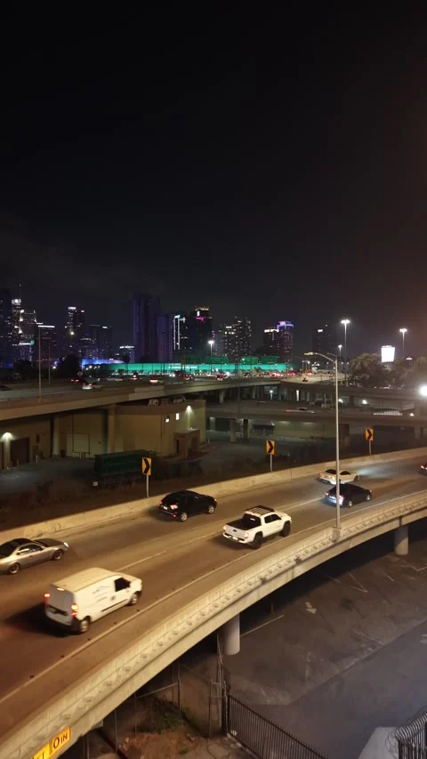 Vertical Drone Rise Beside Los Angeles Freeway Overpass at Night Stock Footage 345702926